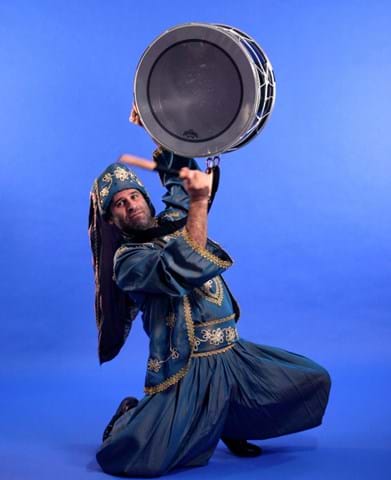 Picture of Al Salaam dancer with a drum in traditional costume